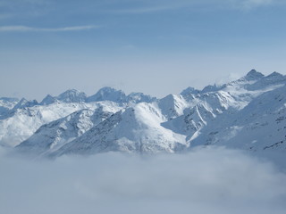 Mountain range above layer of white clouds. beautiful scenery