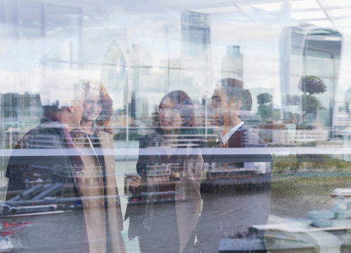 Business people talking at urban window with city view, London, UK
