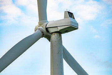 A close up and side shot on the top detail of a wind turbine, showing the nacelle and anemometer....