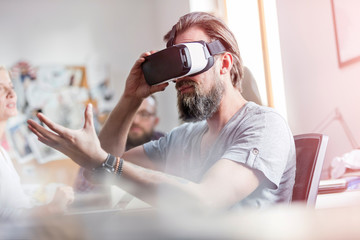 Male design professional using virtual reality simulator glasses in office