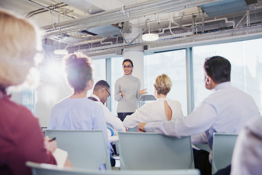 Businesswoman leading conference room meeting