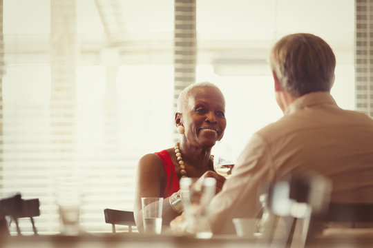 Senior Couple Drinking Wine, Dining At Restaurant Table