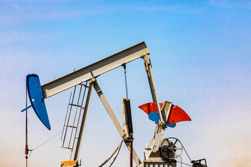 Nodding horse head and walking bar of a mechanical pumpjack closeup, oil mining and gasoline...
