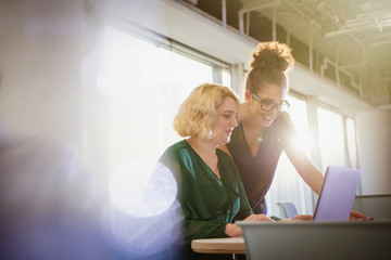 Businesswomen using laptop in office