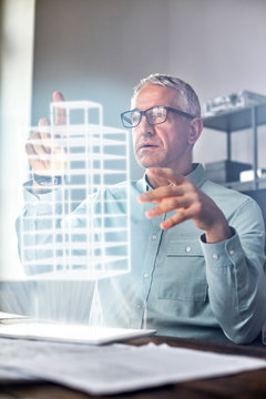 Male architect performing telekinesis, hovering futuristic glowing plastic model