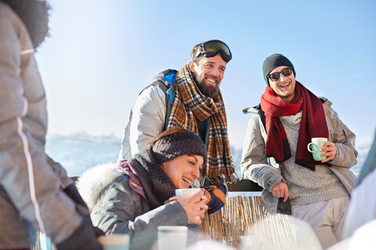 Smiling Skier Friends Drinking Coffee And Hot Cocoa Outside Apres-ski