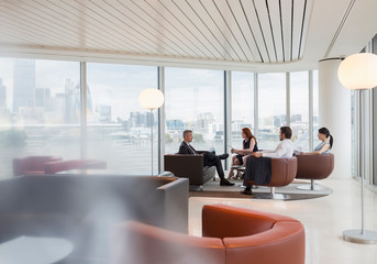 Business people meeting in urban highrise office lounge