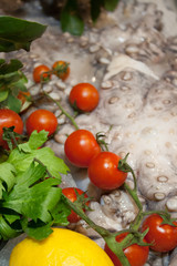 Obraz na płótnie Canvas Fresh Authentic Italian Food Cooking Dinner Ingredients - Octopus, Lemons, Tomatoes