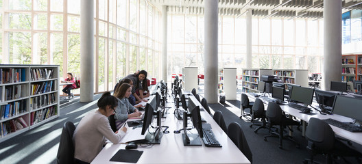 Students researching at computers in library