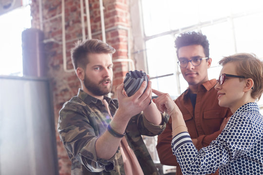 Designers meeting, examining prototype