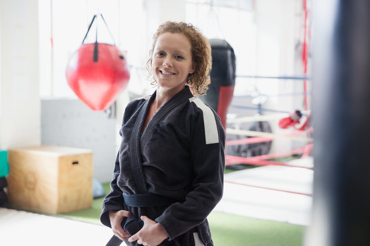 Portrait confident woman in judo uniform in gym