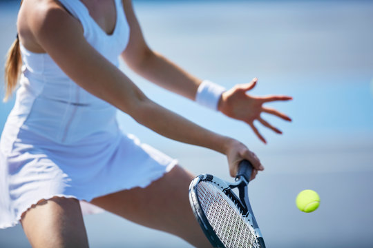 Female tennis player playing tennis, holding tennis racket