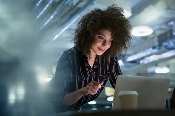 Businesswoman working late at computer in office