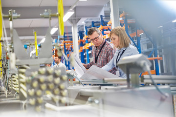Supervisor and engineer discussing plans in fiber optics factory