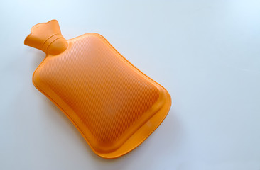 A orange plastic hot water bottle