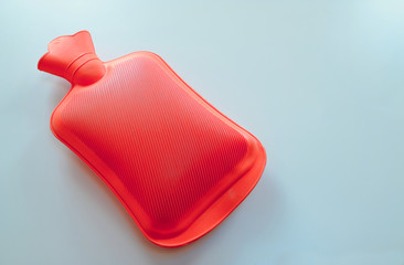 A red plastic hot water bottle