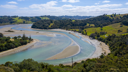 Fototapeta na wymiar Aerial View from the Beach, Ocean, Mountain, Green Trees of Wenderholm Regional Park in New Zealand - Auckland Area