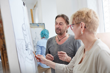 Artists sketching in art class studio
