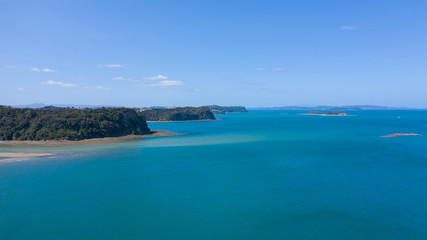 Fototapeta na wymiar Aerial View from the Beach, Ocean, Green Trees of Wenderholm Regional Park in New Zealand - Auckland Area