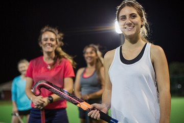 Portrait smiling, confident young female field hockey players