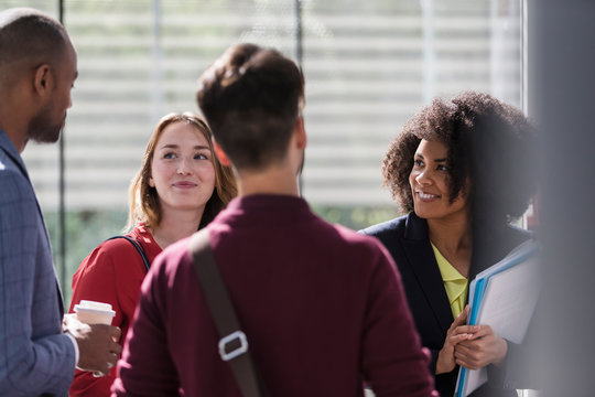 Smiling business people talking in office