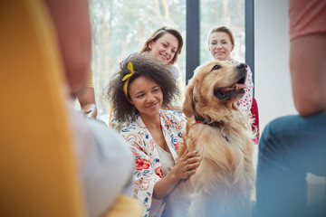 Woman petting dog in group therapy session