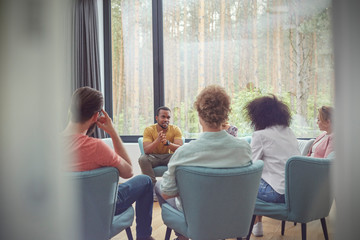 Man talking in group therapy session