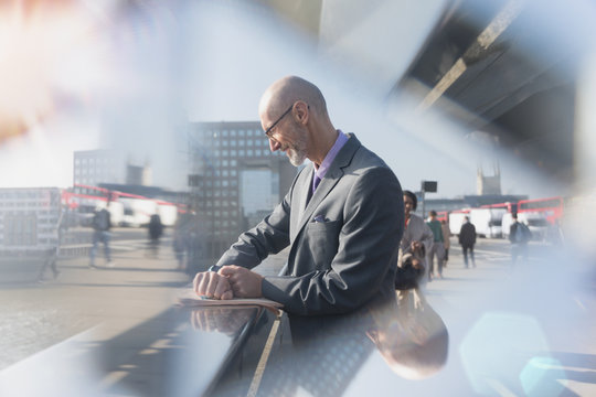 Businessman checking smart watch on urban street