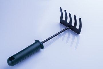 Short hand garden rake. Isolated on white background.
