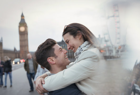 Romantic, affectionate couple tourists hugging near Big Ben, London, UK