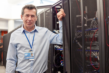 Portrait confident male IT technician in server room