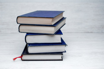 stack of books on wooden desk