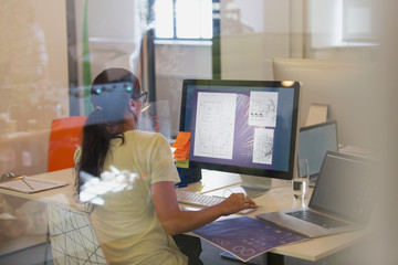 Female designer using computer in office