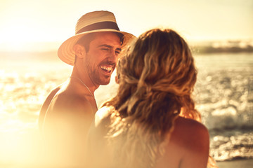 Laughing young couple on sunny summer beach