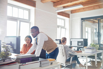 Businessman and businesswoman using computer in office