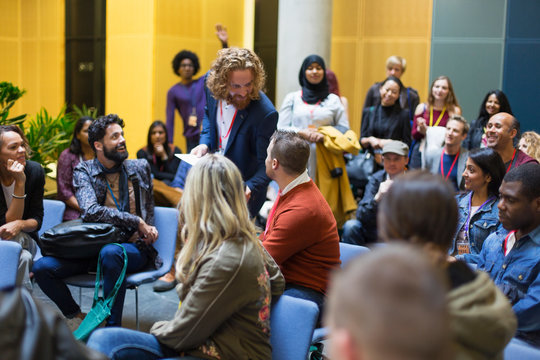 Audience watching speaker and man talking at conference