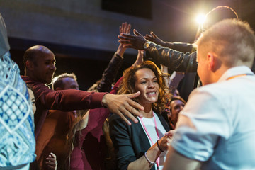 Audience reaching for and talking with speakers