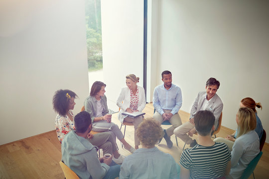 People talking in a circle in group therapy session