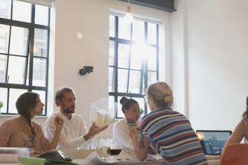 Architects examining model in conference room meeting