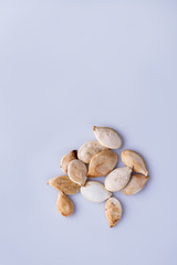 Close-up of dry pumpkin seeds. White isolated background.