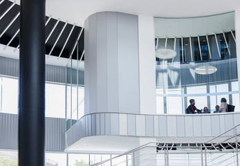 Business people meeting in architectural, modern office conference room window
