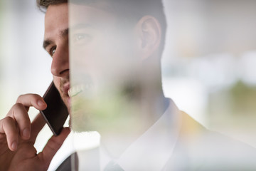 Close up smiling businessman talking on cell phone