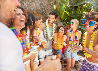 Young friends wearing leis, hanging out at summer poolside
