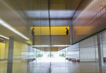 Businessman standing at balcony in modern office