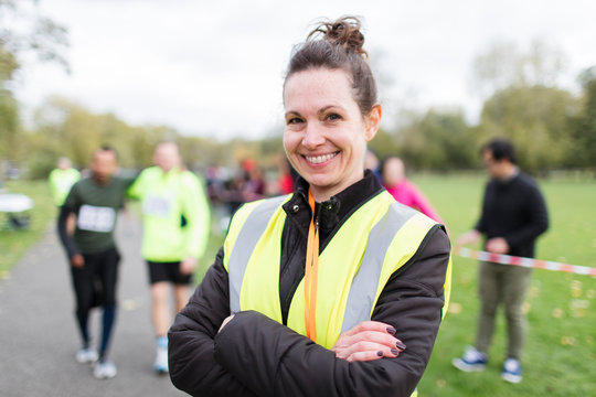 Portrait smiling female volunteer at charity run in park