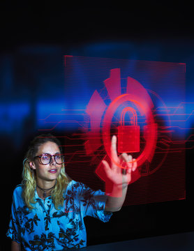 Businesswoman accessing security feature on futuristic hologram computer