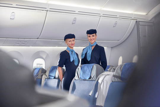 Portrait smiling, confident female flight attendants on airplane