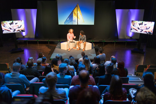 Audience watching speakers on stage