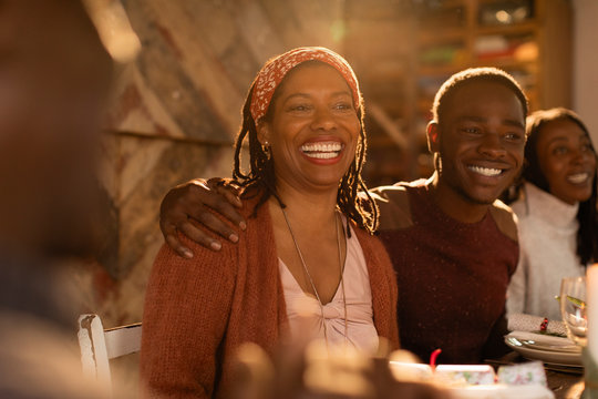Portrait enthusiastic mother son enjoying Christmas dinner with family