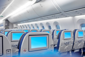 Entertainment screens on seats in airplane